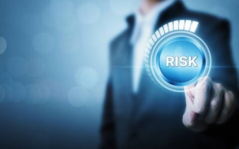 man pointing to risk button