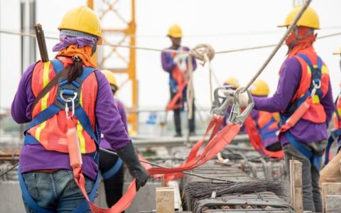 Construction workers dressed in safety gear at a construction site