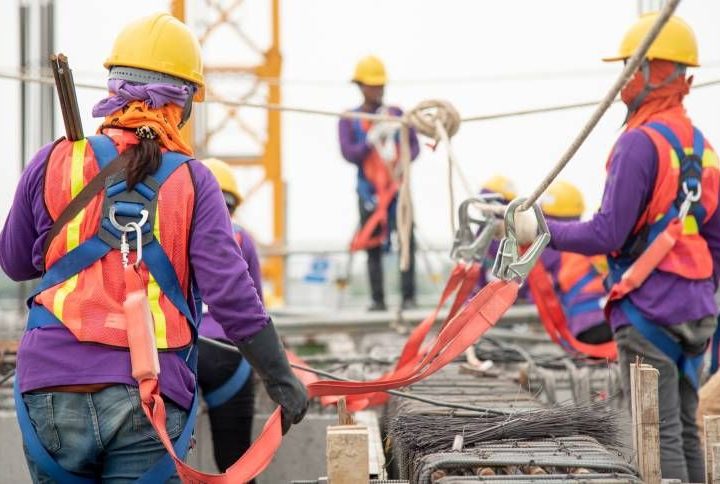 Construction workers dressed in safety gear at a construction site